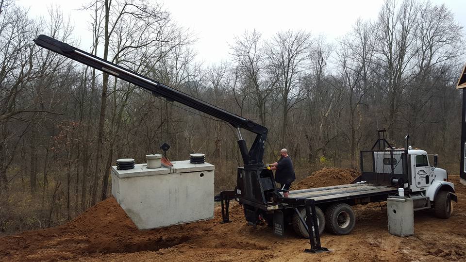 Miller Septic setting a new concrete septic tank with a boom truck