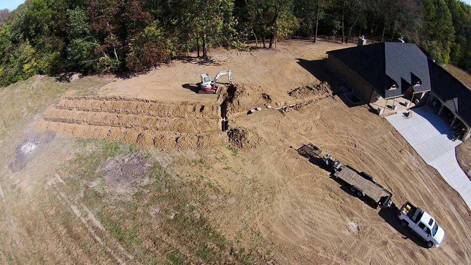 Aerial view of a residential septic system install with trench lines